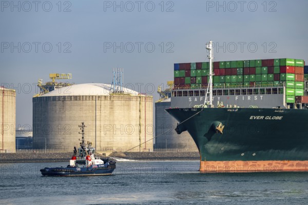 LNG import terminal tanks for liquefied natural gas in the seaport of Rotterdam, harbour tug brings