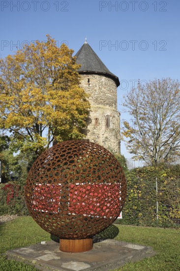 Historic Alexander Tower built in the 15th century and sculpture with ball, lattice, autumn
