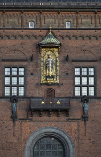 Brick façade with gilded sculpture of Bishop Absalon, St City Hall in the National Romantic style