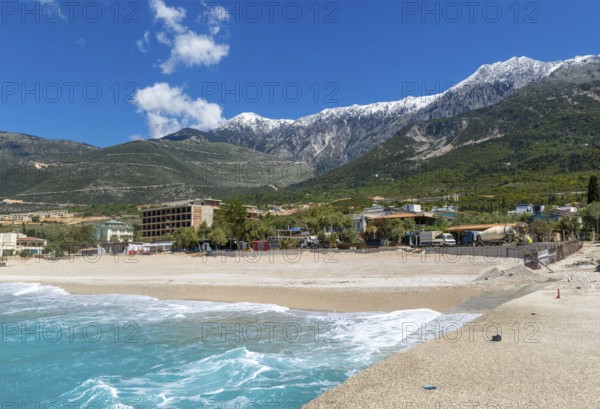 Tourist development construction building work view from Drymades beach to Mount Cika snow capped