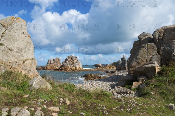 Coastal landscape with rocks, sea view and grassy paths under a cloudy sky, Plage de Pors Scaff,