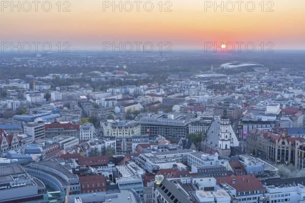 View of the city from the City Tower at sunset, St Thomas' Church, Red Bull Arena and Auwald