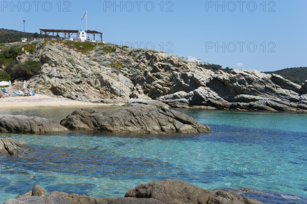 Rocky coastal landscape with crystal clear water and cliffs, peaceful natural scenery, Sarti,