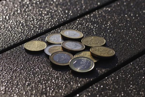 Euro, coins, small change, glow, Various cent and euro coins lie on a table in front of a blurred,