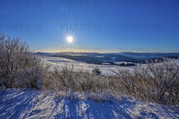 Bright sun over white hills with clear sky, winter, Wasserkuppe, Gersfeld, Rhön, Hesse, Germany,