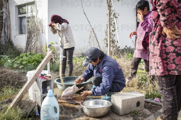 Lu Jua Ling prepares a duck for her colleagues to eat, Duck Breeding Centre Jiang Su Xiang Gui