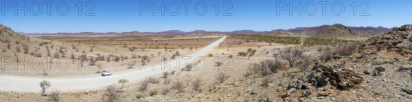 Panorama, gravel track leads through barren dry landscape with hills, Damaraland, Kunene, Namibia,