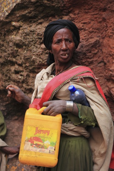 Pilgrim at the rock-hewn churches in Lalibela, container for holy water, Ethiopia, Africa