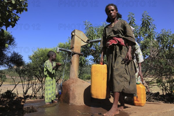 Amhara region, locals fetching water from a well, Ethiopia, Africa