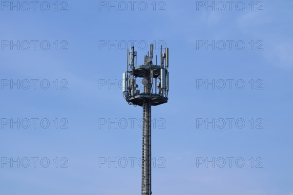 Mobile phone mast, transmission mast in front of sky, Hesse, Germany, Europe