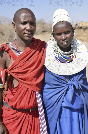 Maasai man and a woman wearing traditional dress, Ngorongoro Conservation Area, Ndema, Tanzania,