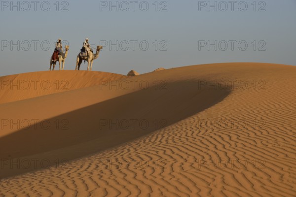 Men on camels in the dunes of Meroe, Black Pharaohs, Nubia, River Nile, Sudan, Africa