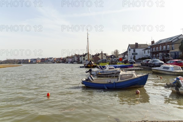 Boats and houses on waterside of River Colne, Rowhedge, Essex, England, UK