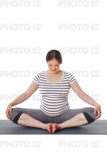 Pregnancy yoga exercise, pregnant woman doing asana Baddha Konasana Bound Angle Pose isolated on