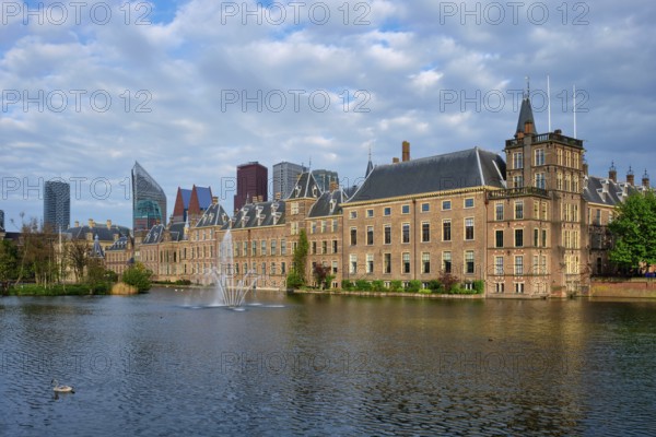 View of the Binnenhof House of Parliament and the Hofvijver lake with downtown skyscrapers in