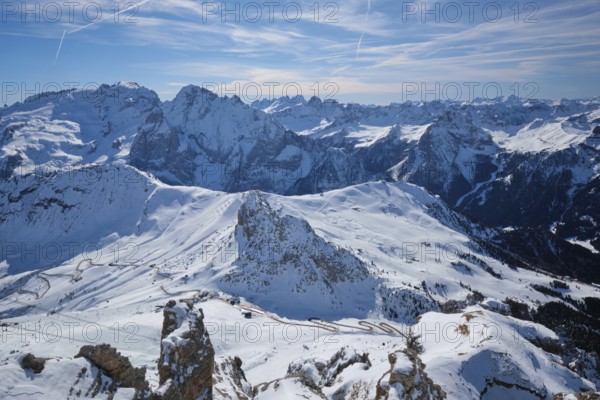 View of a ski resort piste and Dolomites mountains in Italy from Passo Pordoi pass. Arabba, Italy,