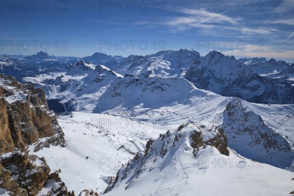 View of a ski resort piste and Dolomites mountains in Italy from Passo Pordoi pass. Arabba, Italy,