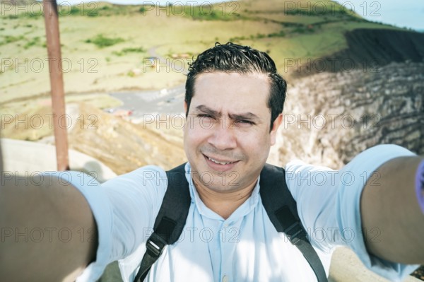 Close up of man taking an adventure selfie, Tourist taking a selfie at a viewpoint. Adventurous