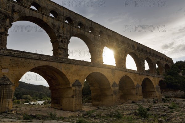 Pont du Gard, Roman aqueduct over the River Gardon, Sunbeams, Languedoc-Roussillon, South of