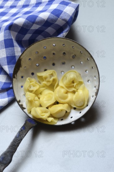 Cappelletti, cooked pasta in a sieve ladle, pasta