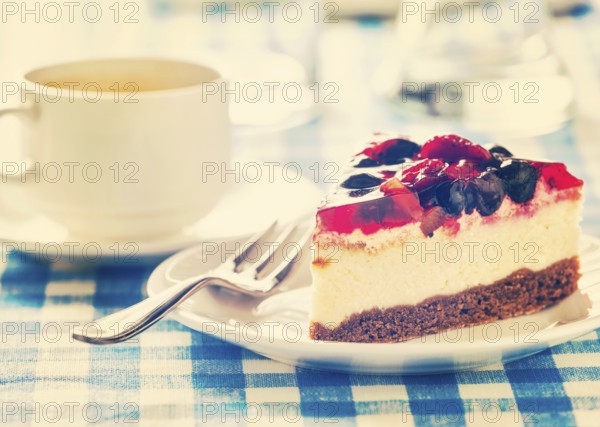 Vintage retro effect filtered hipster style image of dessert fruit cheese cake on plate with fork