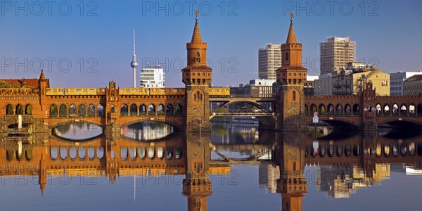 Oberbaum Bridge over the Spree with yellow underground and television tower,