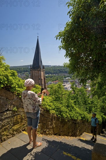 Elevated view from the Schlossberg to the church tower of St. Marien and the steep staircase into