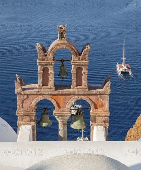 Old belfry wiith yacht and blue sea, Ia, Oia, Santorini, Greece, Europe