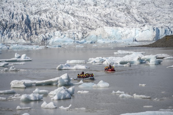 Boats with tourists in the glacier lagoon, ice lagoon Fjallsárlón, ice floes in front of glacier