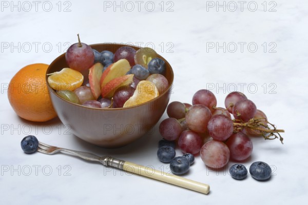 Various pieces of fruit in bowl, fruit salad