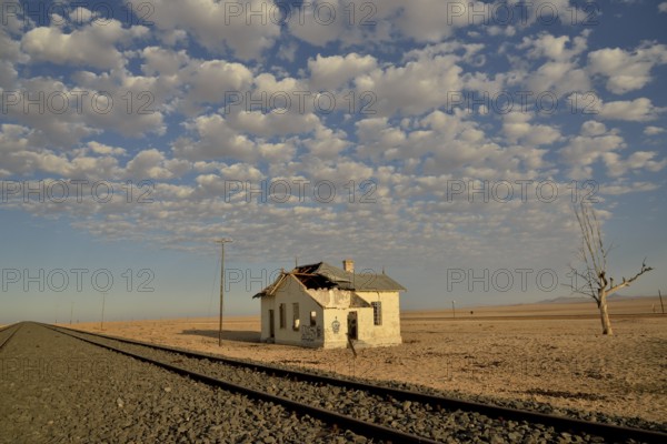Derelict house by railroad tracks, former German railway station of Garub, Aus, Karas Region,