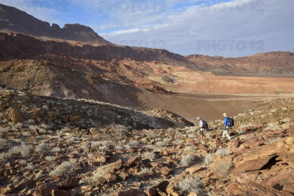 Hikers in the amphitheatre near De Riet, Huab Dry River, Kunene region, Namibia, Africa