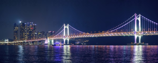 Panorama of Gwangan Bridge and skyscrapers illuminated in the night. Busan, South Korea, Asia