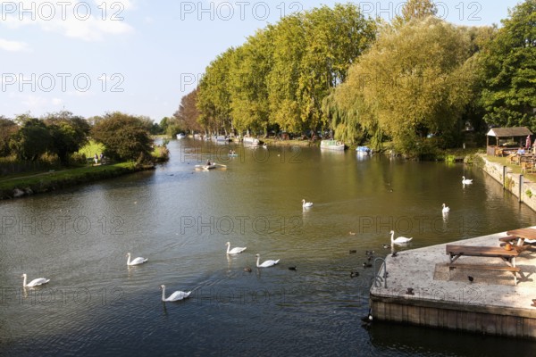 Boats on the River Thames in autumn at Lechlade on Thames, Gloucestershire, England, UK