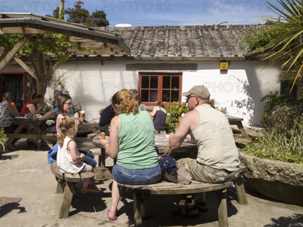 People eating ice cream at Roskilly's farm, near St Keverne, Lizard Peninsula, Cornwall, England,