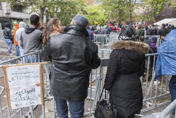 Refugees from Syria waiting to be registered at the Central Reception Centre for Asylum Seekers at