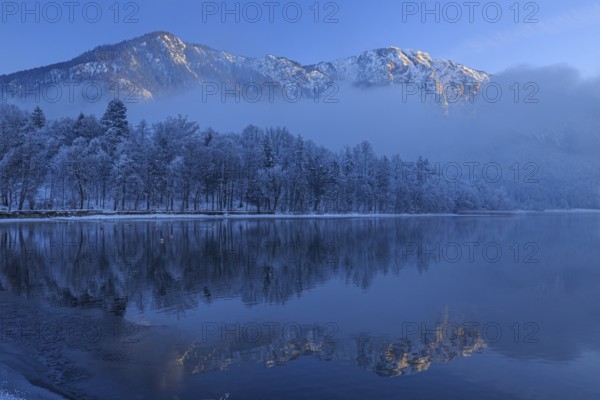 Mountains reflected in lake, winter, snow, evening light, Lake Kochel, foothills of the Alps,