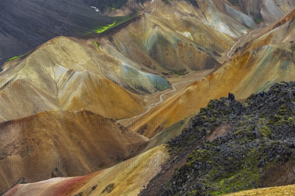 Small river between colourful rhyolite mountains, volcanic landscape, erosion landscape, view from