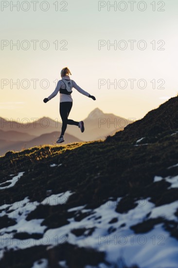 Trail running in autumn on the Jochberg on Lake Walchensee against the wonderful backdrop of the