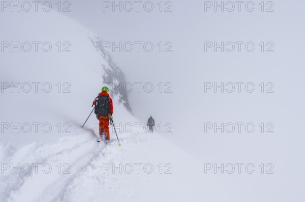 Ski tourers on the Wildhorn, Snowy mountain landscape and fog, Bernese Alps, Bernese Oberland,