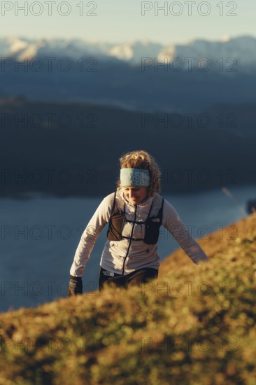 Trail running in autumn on the Jochberg on Lake Walchensee against the wonderful backdrop of the