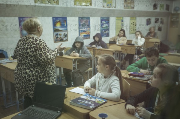 Pupils in a classroom in one of the metro schools in Kharkiv. Classrooms were set up in various
