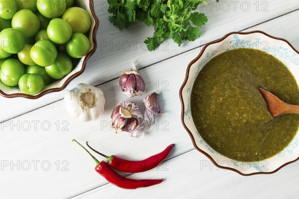 Tkemali sauce, traditional Georgian cuisine, green cherry plum, with ingredients for sauce,