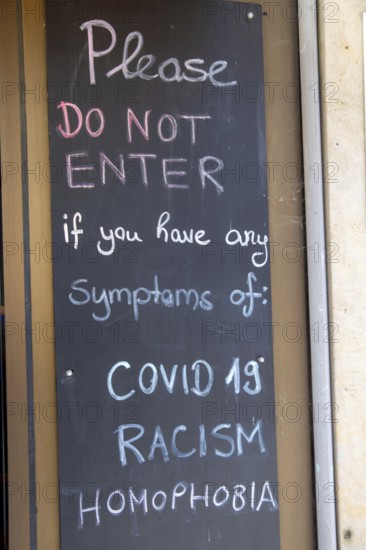 Display in front of a pub in Germany: Guests are warned in English that they are not welcome with