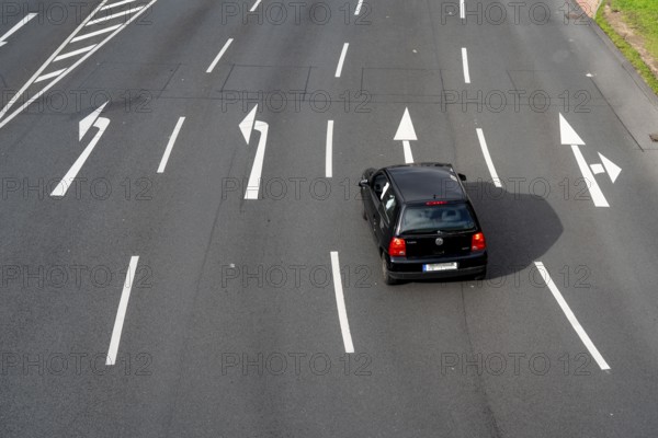 Road markings, turning lanes, directional signage at an intersection, turning, straight ahead,