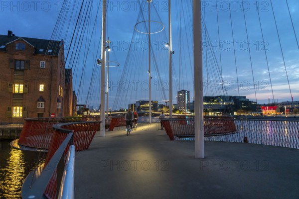 Cyclists on the Cirkelbroen cycle and pedestrian bridge, over the harbour, in the Christianshavens