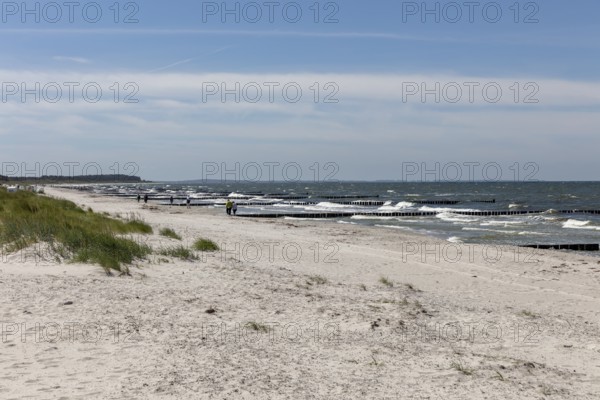 Wide beach landscape with a view of the sea and gentle waves under a blue sky, Rügen, Hiddensee