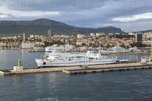 White blue and red Jadrolinija Oliver ferry boat docked at terminal in Port of Split in late