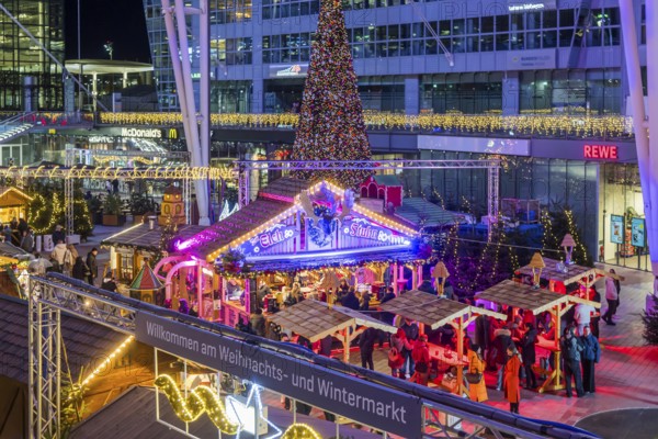Christmas market at the airport in the evening, market stalls decorated for Christmas in front of