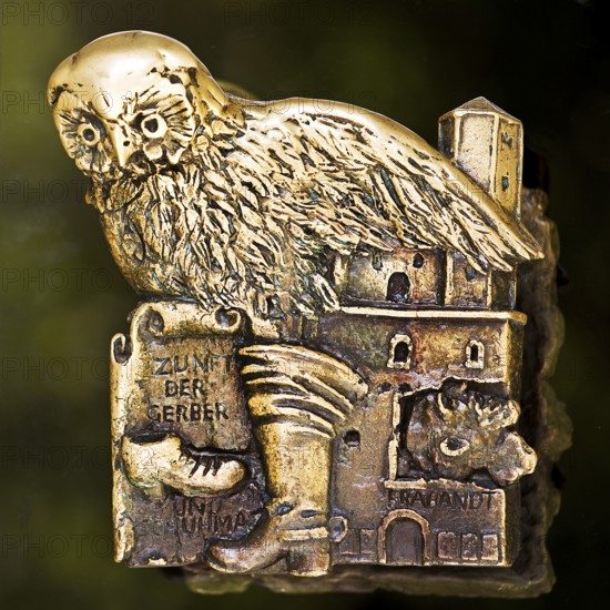 Door handle on the glass door of the town hall with motifs from the history of the city of